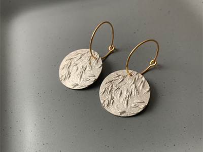 Gold earrings with leaf pattern