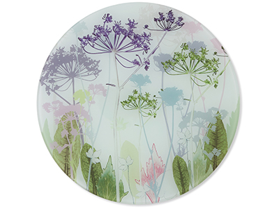 A white disc of fabricdecorated with purple and green flowers