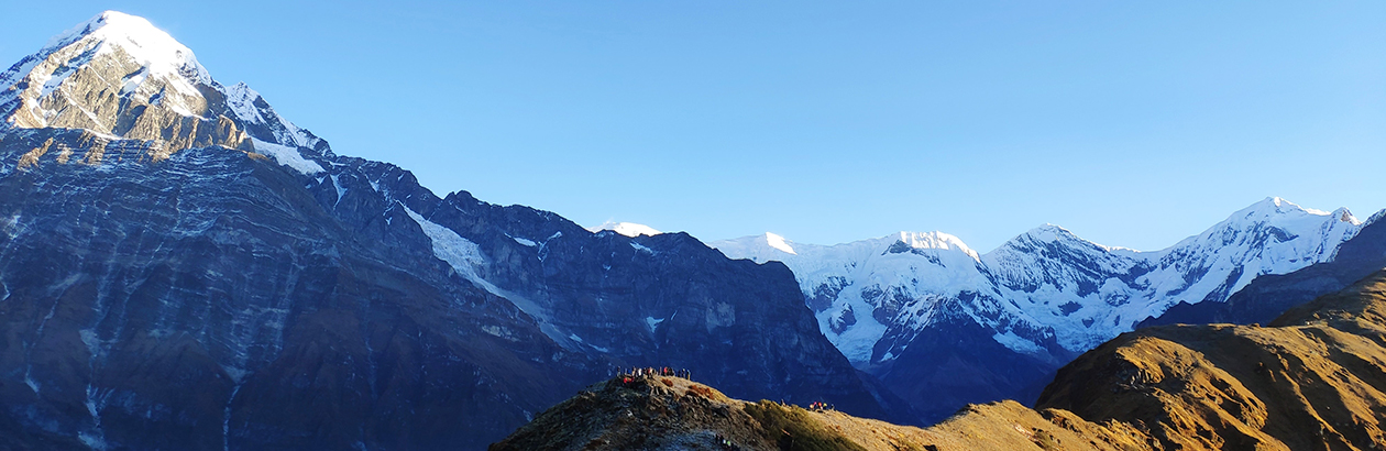 Mountain range in Nepal. Peak on left with lower mountain in centre foreground