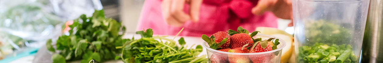 Person cutting preparing food with strawberries