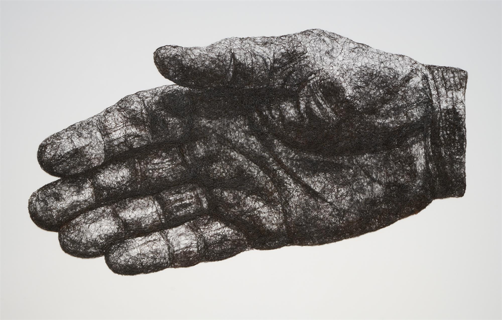 A flat image of a hand made from black wire on a white wall