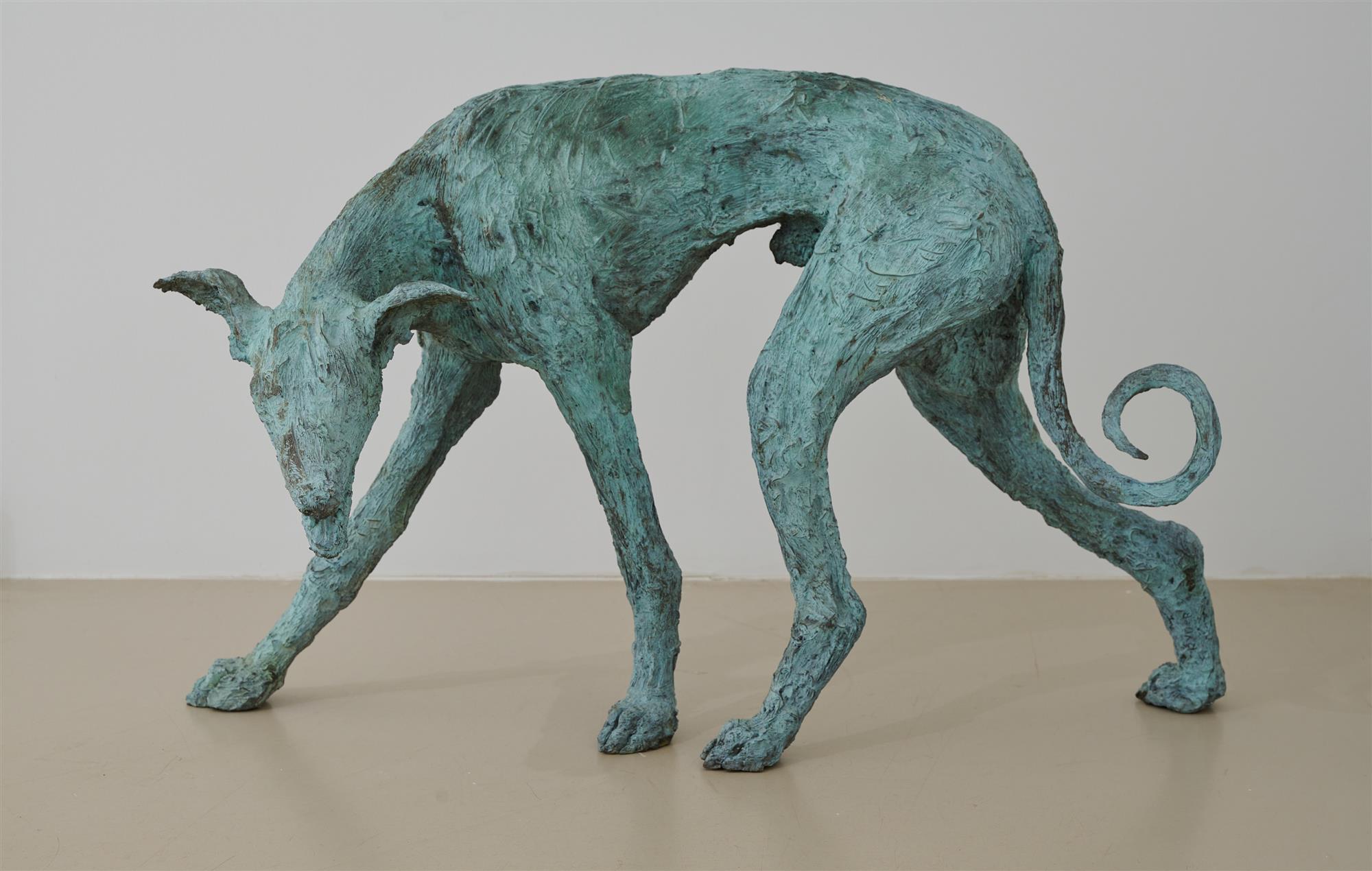 A sculpture of a dog made from bronze