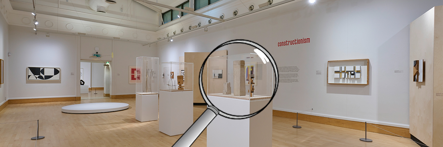 A gallery filled with minimalist art and a magnifying glass over the top