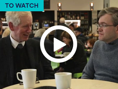 Dr Nigel Astor on left and Richard Gaunt on right sitting at cafe table. Keyword in the corner TO WATCH