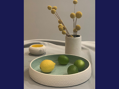 White plant pots and bowls with bobbled texture and blue insides