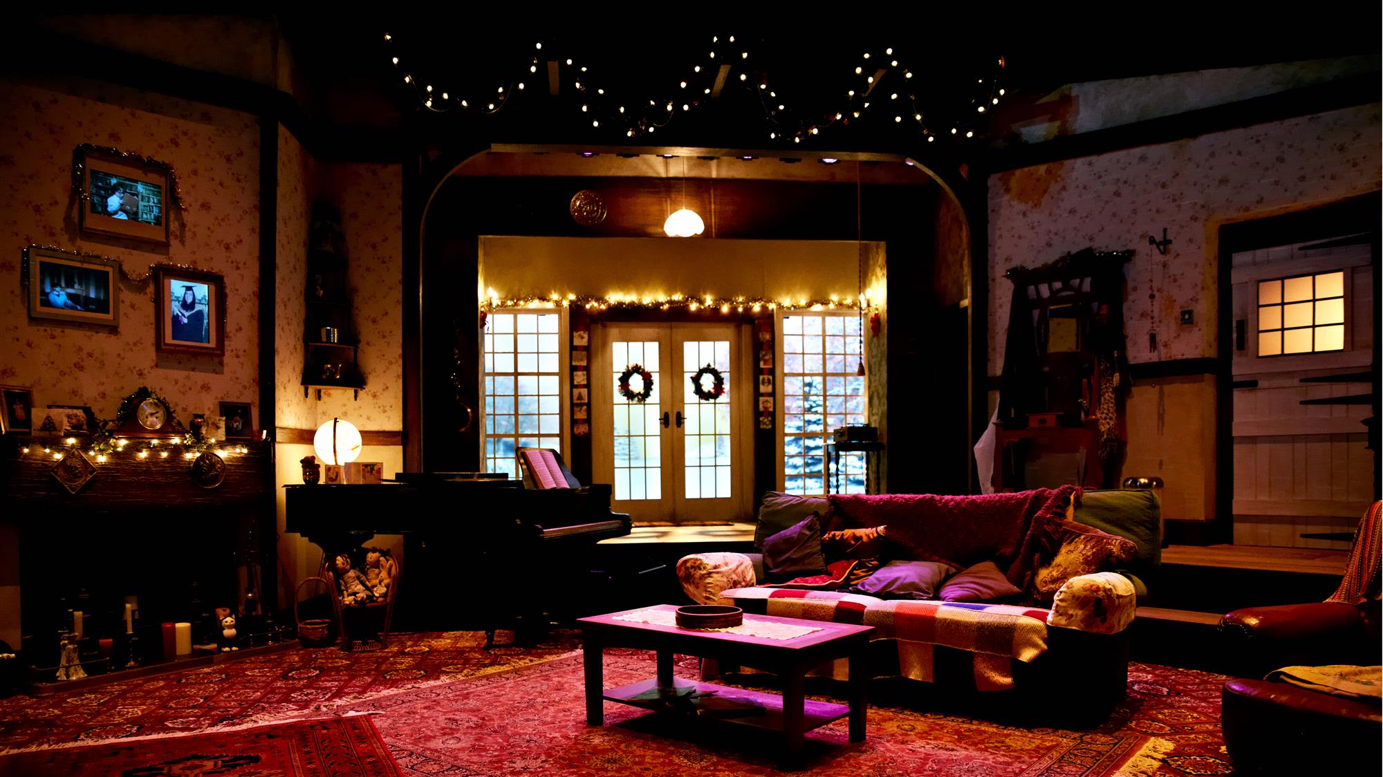 Photo of set design of The Christmas Carol, 2013, with a cozy home's interior with Christmas decorations