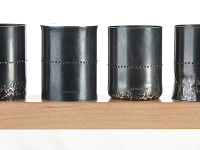 An image of four designer metal vases