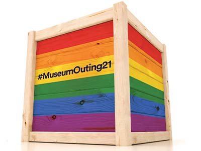 A large rainbow coloured wooden crate with the words #MuseumOuting21 written on it
