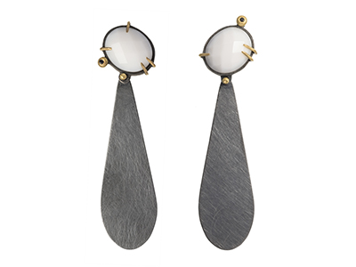 Natalie Harris earrings made of grey triangles that dangle from pearl white gems