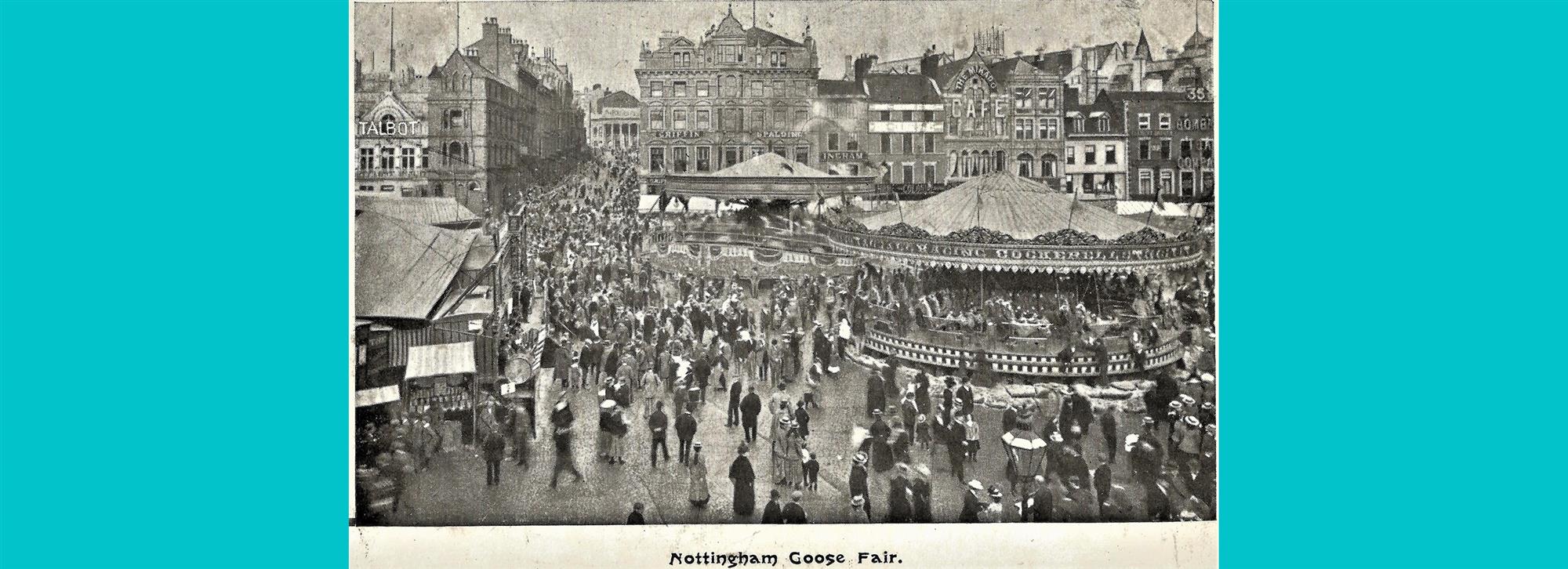 Photograph of people walking at goose fair in nottingham with fair rides 