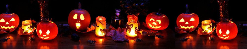 Halloween pumpkins with candle-lit jars in Halloween-themed display