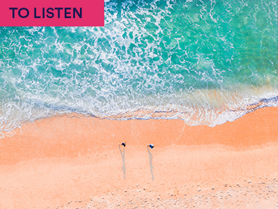 Photograph of blue sea against white sands with two people standing on edgen with keyword:TO LISTEN