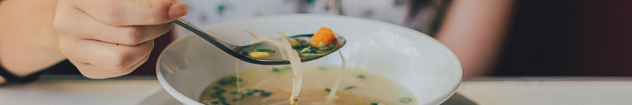 Woman eating chicken soup