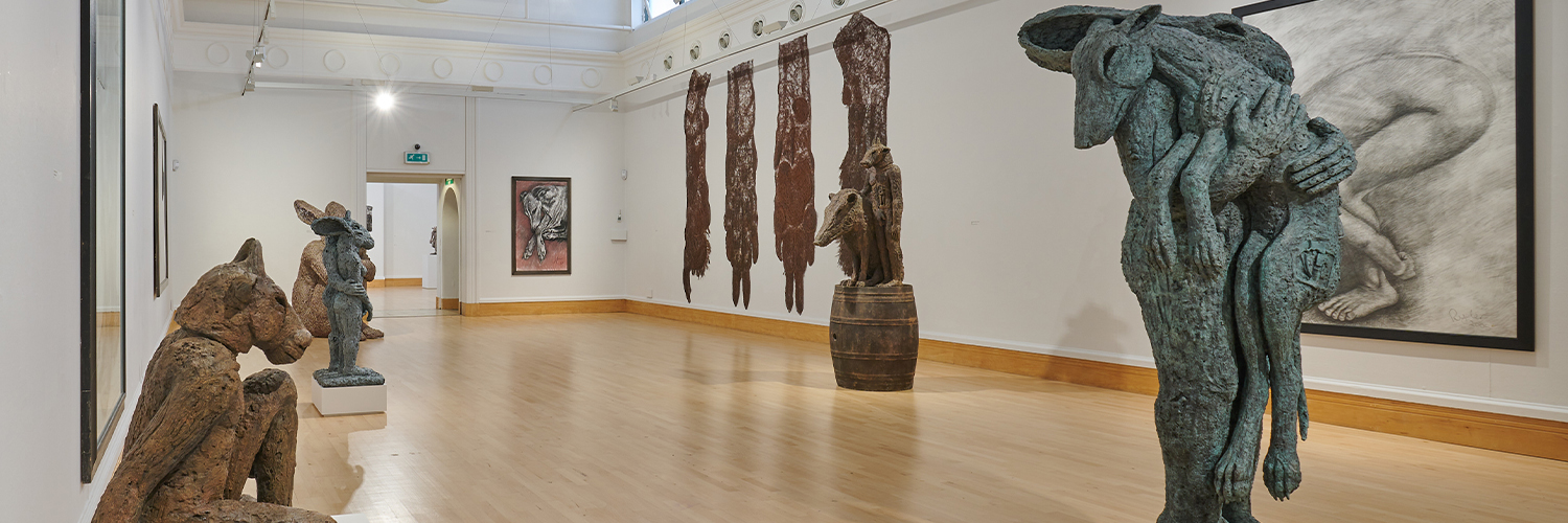 A gallery space filled with sculptures 
