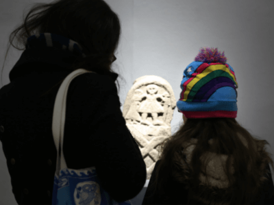 Mother and daughter looking at Viking stone in exhibition at Lakeside
