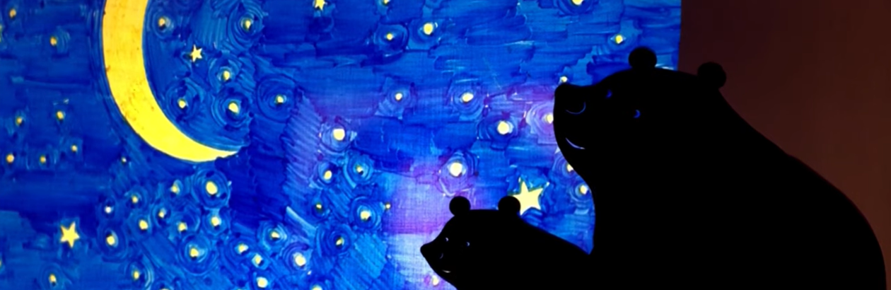 A big bear and little bear made of black card positioned in midnight sky, yellow moon and stars